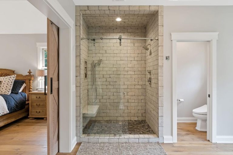 Modern bathroom with walk-in shower featuring subway tile walls and glass enclosure doors