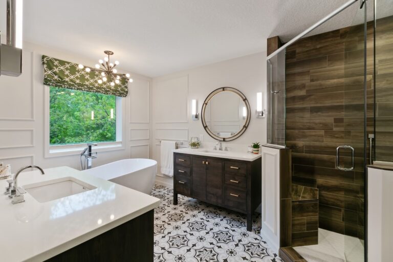 Modern luxury bathroom with double vanity, freestanding tub, walk-in shower, and marble tile flooring