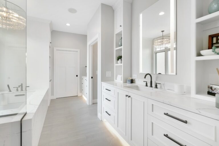 Modern white bathroom with double vanity, mirror cabinets, and tile flooring